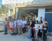 Group of people cutting ribbon for school opening